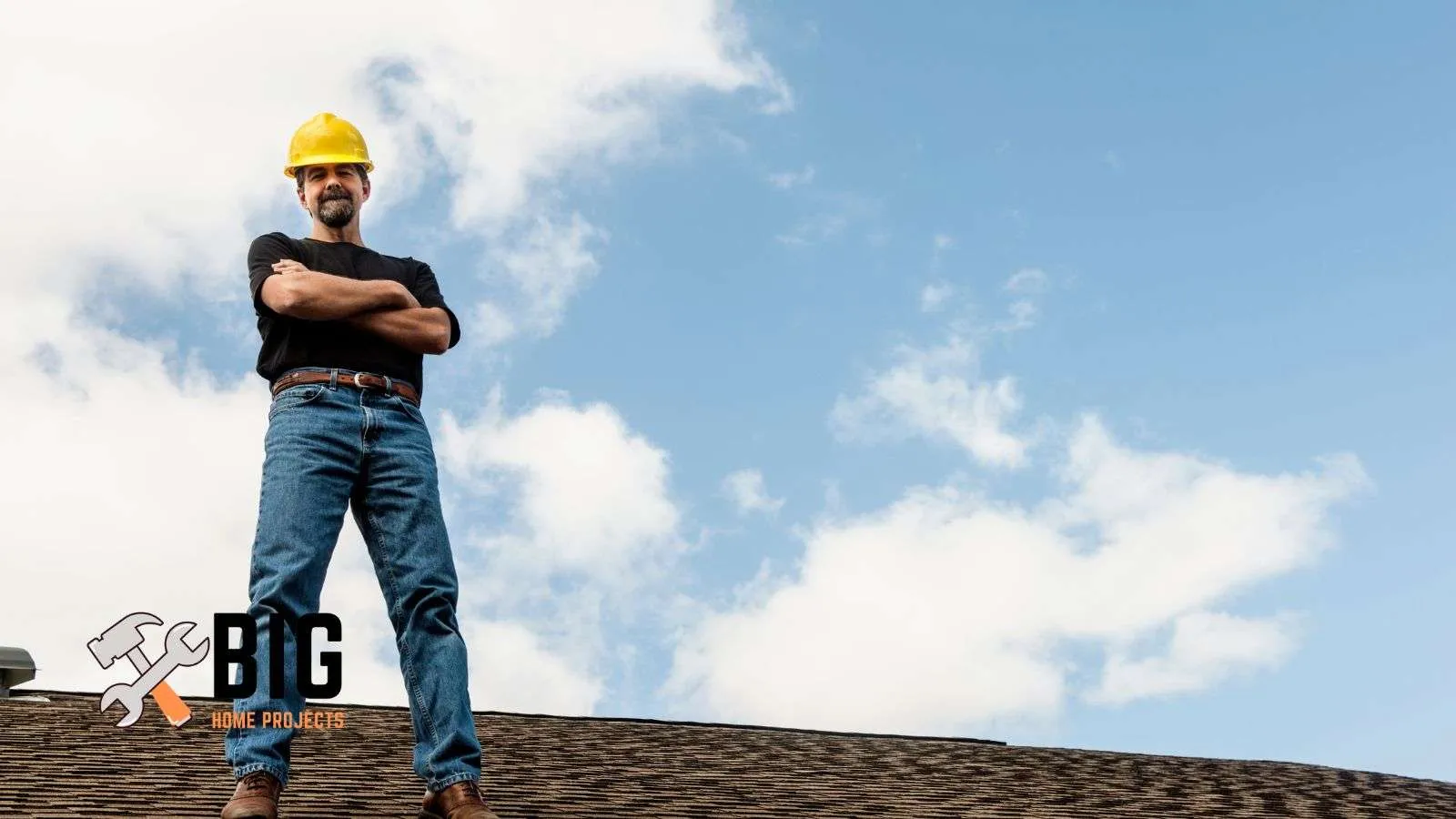 Construction worker standing on top of a roof - bighomeprojects.com