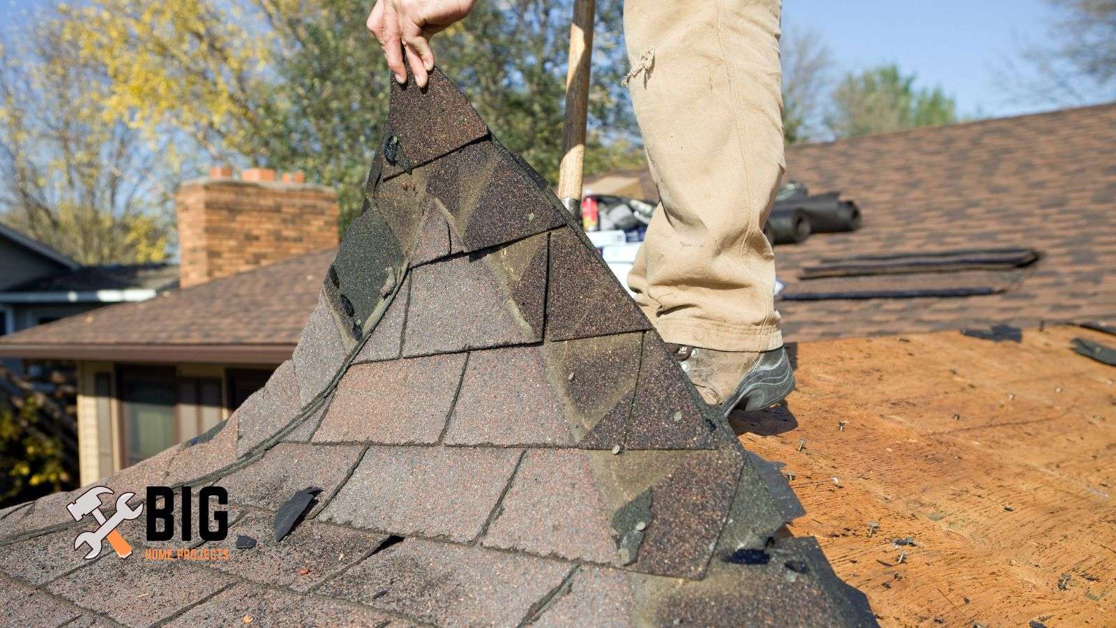Roofer removing old shingles - bighomeprojects.com