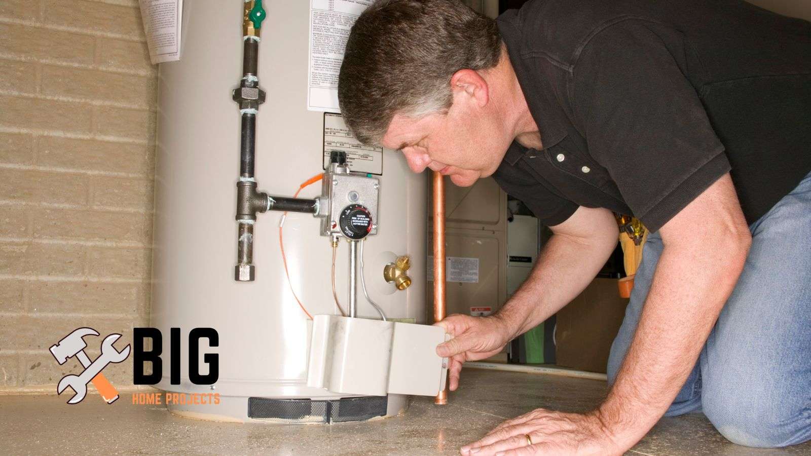 Plumber working on a water heater - bighomeprojects.com