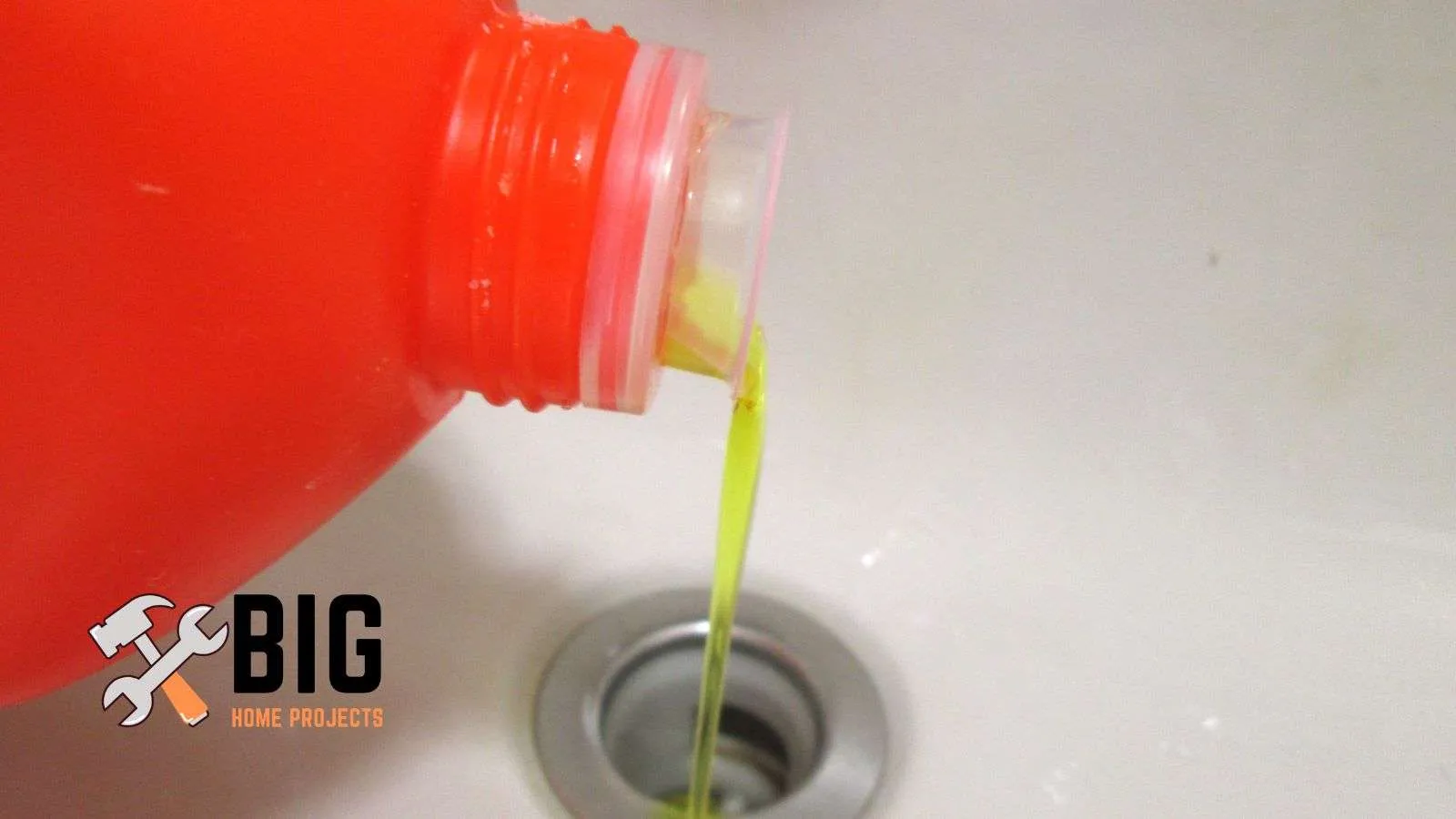 Plumber pouring drain cleaner into a sink drain - bighomeprojects.com