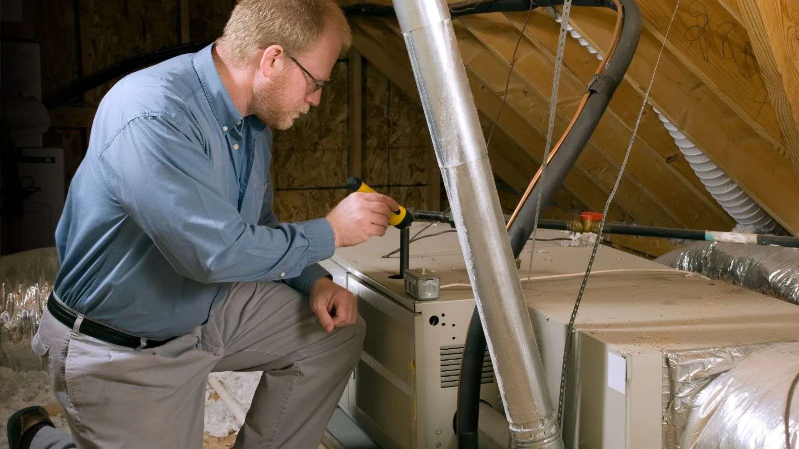 HVAC inspector inspecting furnace - bighomeprojects.com