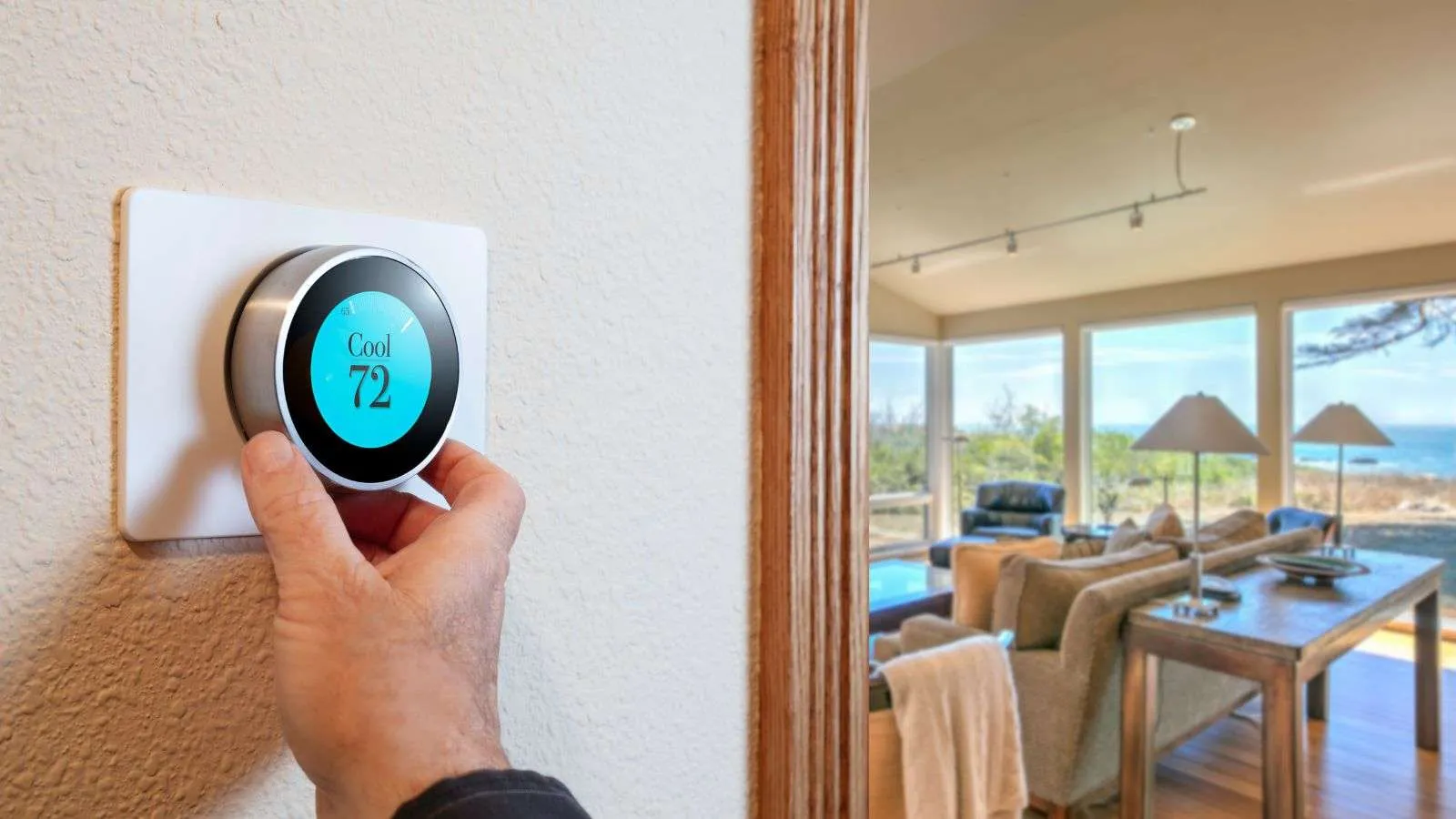 Person changing his thermostat settings - bighomeprojects.com