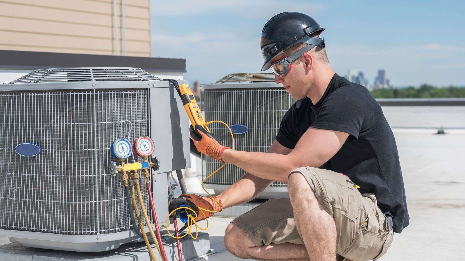 HVAC technician working on an HVAC - bighomeprojects.com