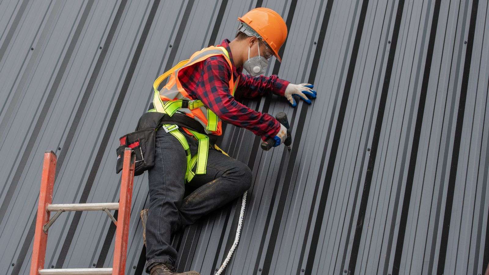 Roofer installing aluminum roof - bighomeprojects.com