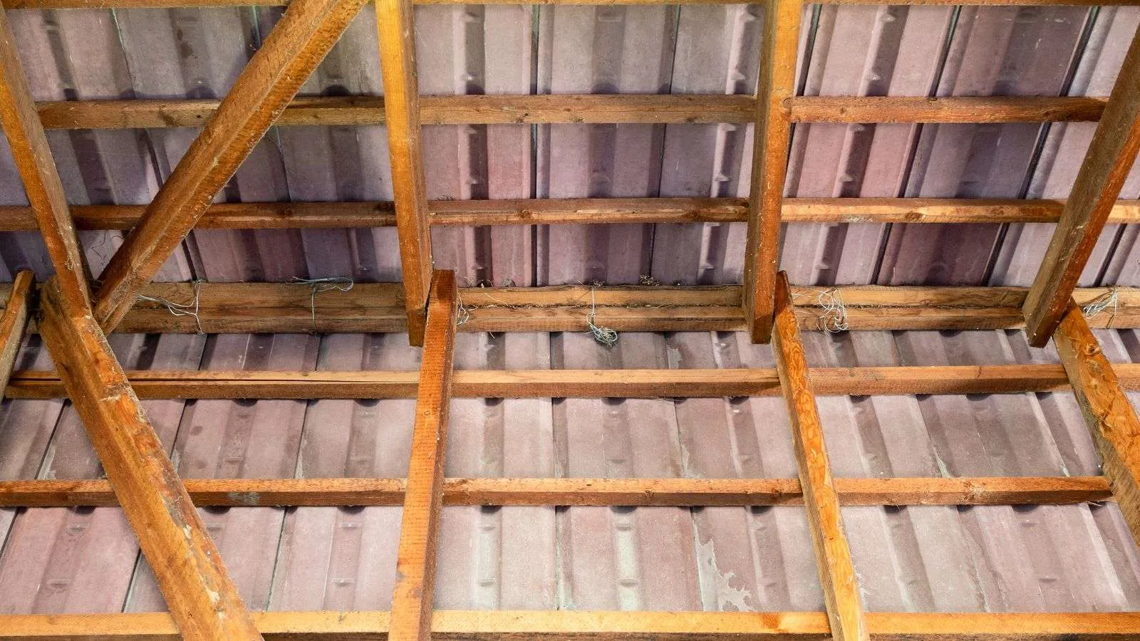 The correct spacing of purlins on metal roofs is essential for both the integrity and longevity of the roofing system. Misaligned or inaccurately spaced purlins can lead to structural issues, leaks, and decreased load capacity. In this article, we will dive into the guidelines and considerations necessary for optimal purlin spacing on metal roofs. Understanding Purlin Spacing on Metal Roofs To determine the appropriate purlin spacing on metal roofs, several factors must be considered, such as the expected loads on the roof, the type of metal roofing being used, and local building codes. Purlins should be spaced closer together in areas with heavy snow loads or where strong winds are common so that the roof's structural integrity can be maintained. For instance, in regions with heavy snowfall, purlins may need to be spaced around 2 feet apart to adequately support the weight of the snow. The type of metal roofing being used will influence the purlin spacing, as heavier roofing materials may require closer purlin spacing for support. Local building codes often provide guidelines on the minimum and maximum allowable purlin spacing based on factors like roof slope and expected loads. You have to follow these guidelines to ensure the safety and durability of the metal roof structure. 5 Essential Guidelines for Purlin Spacing 1. Consider Roof Load Requirements Determining the appropriate purlin spacing on metal roofs starts with considering the expected roof loads. Understanding the specific load requirements for your location, such as snow loads or wind loads, is crucial in establishing the ideal purlin spacing. Be sure to consult local building codes or a structural engineer to make sure the purlin spacing meets the necessary load-bearing criteria. Consider potential future changes in weather patterns or building usage when deciding on purlin spacing to guarantee long-term structural integrity. 2. Account for Roofing Material Weight Different types of metal roofing materials have varying weights, which can impact the required purlin spacing. Heavier roofing materials will necessitate closer purlin spacing to adequately support the weight of the roof. When selecting metal roofing for your project, be mindful of the material's weight and consult with the manufacturer or a construction professional to determine the optimal purlin spacing for your specific roofing material. 3. Optimize for Structural Stability Achieving structural stability is paramount when determining purlin spacing on metal roofs. To enhance the overall stability of the roof structure, consider reinforcing purlin connections at critical points such as intersections and edges. Implementing diagonal bracing or cross-bracing between purlins can further enhance structural rigidity and prevent roof movement or distortion under varying loads. Prioritize structural stability for the longevity and safety of your metal roof. 4. Follow Manufacturer Recommendations Consulting the manufacturer's guidelines and recommendations for purlin spacing is essential to guaranteeing the proper installation and performance of your metal roof. Manufacturers often provide specific instructions regarding purlin spacing based on the design and specifications of their roofing products. Adhering to these recommendations will not only ensure compliance with warranty terms but also optimize the functionality and longevity of the metal roof system. 5. Regular Maintenance and Inspection After installing a metal roof with the recommended purlin spacing, it's best to perform regular maintenance and inspections to detect any issues early on and prevent potential damage. Inspect the roof periodically for signs of corrosion, loose fasteners, or purlin deflection, as these issues can compromise the integrity of the roof structure. Dealing with maintenance concerns quickly and conducting routine inspections will extend the lifespan of your metal roof and maximize its performance over time. The Impact of Roof Pitch on Purlin Spacing The roof pitch plays a significant role in determining the purlin spacing on metal roofs, influencing both the structural integrity and aesthetic appeal of the roof. For roofs with a steeper pitch, the purlin spacing may need to be closer to accommodate the increased gravitational forces acting on the roof surface. Steeper roof pitches result in a more vertical load on the purlins due to gravity, requiring tighter spacing for adequate support and stability. Conversely, roofs with a shallower pitch can typically have wider purlin spacing since the gravitational load is spread out more horizontally. It is essential to consider the roof pitch when determining purlin spacing to get the right weight distribution, structural support, and overall functionality of the metal roof system. Calculating the Maximum Span for Purlins on Your Metal Roof Determine the required load capacity. Begin by evaluating the expected loads on your metal roof, such as snow loads or wind loads, based on your location and local building codes. Consider any additional loads, like HVAC units or solar panels, that may impact the purlin span requirements. For example, in areas with heavy snowfall, you may need to account for higher snow loads when calculating the maximum span for purlins. Select Appropriate Purlin Material and Size: Choose purlins that are suitable for the expected loads and span requirements of your metal roof. Consider factors such as material strength, corrosion resistance, and compatibility with your roofing system. For instance, galvanized steel purlins are commonly used for their durability and load-bearing capacity. Consult load span tables or structural engineers. Utilize load span tables provided by purlin manufacturers to determine the maximum allowable span for the selected purlin material and size. Alternatively, seek guidance from structural engineers to calculate the maximum span based on the specific design requirements of your metal roof. These resources will help make sure the purlins can adequately support the roof loads over the desired span. Account for Roof Pitch and Roofing Material Weight: Adjust the calculated maximum span based on the roof pitch and the type of metal roofing material being used. Steeper roof pitches and heavier roofing materials may require shorter purlin spans to accommodate the increased gravitational forces. Just make sure that the purlin spacing aligns with the roof pitch and roofing material weight to maintain structural integrity. Consider Purlin Spacing and Connection Details: Determine the appropriate spacing between purlins based on the calculated maximum span, load requirements, and structural stability considerations. Pay attention to the connection details between purlins and roof components to ensure secure attachment and distribution of loads. Implement proper bracing and fastening techniques to enhance the overall strength of the roof structure. Common Mistakes to Avoid in Purlin Installation Improper Purlin Spacing: One common mistake to avoid is improper purlin spacing, which can lead to insufficient support for the metal roof and compromise its structural integrity. Just make sure that the purlins are spaced according to manufacturer recommendations, taking into account factors such as roof loads, roofing material weight, and roof pitch. Incorrect spacing can result in purlins deflecting under load, causing issues like sagging or buckling in the roof system. Neglecting Connection Details: Neglecting proper connection details between purlins and other roof components is another critical error to avoid during installation. Secure and correctly install purlin connections using appropriate fasteners and bracing techniques to ensure stability and load distribution. Failing to address connection details can lead to weak points in the roof structure, increasing the risk of failure during extreme weather conditions or over time. Ignoring Manufacturer Guidelines: Disregarding manufacturer guidelines and recommendations for purlin installation can result in subpar performance and potential safety hazards. Always follow the manufacturer's instructions regarding purlin material, size, spacing, and installation methods to guarantee the longevity and functionality of the metal roof system. Manufacturer guidelines provide essential information tailored to specific roofing products, ensuring proper installation practices are followed. Lack of Regular Maintenance: Overlooking regular maintenance and inspections of the metal roof after purlin installation is a mistake that can shorten the roof's lifespan and lead to costly repairs. Schedule routine inspections to check for signs of corrosion, loose fasteners, or purlin deflection, addressing any issues immediately to prevent further damage. Implementing a proactive maintenance plan will extend the durability and performance of the metal roof over time. The Role of Purlins in Overall Roof Strength and Stability Purlins play a big role in enhancing the overall strength and stability of a metal roof by providing structural support and load distribution. Positioned horizontally across the rafters or trusses, purlins help to transfer the weight of the roof system, including live loads such as snow or wind, to the vertical supports. Purlins help the roof stand up to outside forces and keep the structure from breaking by spreading out the weight evenly and easing the stress on each part of the roof. Purlins assist in maintaining the shape and alignment of the roof, preventing deflection, and ensuring a uniform load-bearing capacity across the structure. Properly designed and installed purlins are essential for reinforcing the roof system and enhancing its overall durability and stability. Material Choices for Purlins and Their Impact on Spacing Consider Material Strength and Weight: The choice of material for purlins significantly impacts the spacing requirements on a metal roof. Opt for materials with adequate strength to support the intended loads without excessive deflection. For example, steel purlins are commonly used for their high strength-to-weight ratio, allowing for longer spans between supports compared to timber purlins. Evaluate Corrosion Resistance: Selecting purlin materials with good corrosion resistance is essential for maintaining the structural integrity of the roof system over time. Materials like galvanized steel or aluminum, which offer superior corrosion resistance properties, can withstand harsh weather conditions and environmental exposure, reducing the need for frequent maintenance and replacement. Assess Thermal Conductivity: Consider the thermal conductivity of the purlin material, as it can impact the energy efficiency and insulation properties of the roof. Materials with high thermal conductivity may contribute to heat loss or gain through the roof structure, affecting the overall energy performance of the building. Opting for materials with lower thermal conductivity can help improve the thermal efficiency of the roof system. Evaluate Long-Term Durability: Choose purlin materials that exhibit long-term durability and resistance to degradation over time. Materials that are prone to warping, rotting, or decay can compromise the structural stability of the roof and require frequent maintenance or replacement. Investing in durable materials like treated steel or composite purlins can help with a longer lifespan for the roof system with minimal upkeep. How Weather Conditions Influence Purlin Spacing and Placement Weather conditions have a significant impact on purlin spacing and placement in metal roof installations, affecting both structural integrity and performance. Regions prone to heavy snow loads may require closer purlin spacing to adequately support the weight of accumulated snow and prevent roof deformation or collapse. In areas with high wind loads, purlins may need to be strategically placed to resist uplift forces and ensure the roof's stability during storms. Extreme temperature variations can influence the thermal expansion and contraction of the roof system, necessitating considerations for purlin placement to accommodate potential movement without compromising the roof's structural integrity. Adjusting Purlin Spacing for Different Types of Metal Roofs Consider Roofing Material Weight: Different types of metal roofing materials have varying weights, influencing the required purlin spacing. Heavier roofing materials, such as steel panels, may necessitate closer purlin spacing to adequately support the increased weight compared to lighter materials like aluminum. Adjusting purlin spacing based on the specific weight characteristics of the chosen metal roofing material ensures proper load distribution and structural stability. Account for Roof Slope and Pitch: The slope and pitch of the roof impact how loads are distributed, affecting the optimal purlin spacing for different types of metal roofs. Steeper roof slopes concentrate more weight vertically, requiring closer purlin spacing to support the gravitational forces effectively. In contrast, roofs with shallower pitches disperse loads more horizontally, allowing for wider purlin spacing while maintaining structural integrity. Consider Roof Configuration and Design: The design and configuration of the metal roof, such as its shape, size, and intended use, can influence purlin spacing requirements. Complex roof designs with irregular shapes or multiple levels may necessitate varied purlin spacing to accommodate load-bearing needs across different sections of the roof. Customized purlin placement based on the specific roof configuration ensures uniform support and stability throughout the structure. Consult Manufacturer Guidelines: Manufacturers of metal roofing products often provide recommendations on purlin spacing based on the design and specifications of their materials. Following manufacturer guidelines makes sure that the purlin spacing aligns with the structural requirements of the specific metal roof product, optimizing performance and longevity. Consulting these guidelines helps tailor purlin spacing to the unique characteristics of different types of metal roofs, enhancing overall system efficiency. Cost Implications of Purlin Spacing Decisions Decisions regarding purlin spacing in metal roof installations can have significant cost implications, impacting both material expenses and installation costs. Closer purlin spacing typically requires more purlins, fasteners, and labor for installation, resulting in higher material and labor costs. For example, reducing purlin spacing from 5 feet to 3 feet might increase material costs by approximately $0.50 to $1 per square foot of roof area due to the additional purlins and fasteners required. Conversely, wider purlin spacing can reduce material and labor costs but may compromise structural integrity and longevity if not appropriately designed. Balancing cost considerations with structural requirements is the key to optimizing the overall cost-effectiveness and performance of the metal roof system. Engineering Considerations for Purlin Spacing in Commercial Projects In commercial projects, engineering considerations for purlin spacing play a vital role in ensuring the structural integrity and longevity of the metal roof system. Engineers must assess the expected loads on the roof, including live loads such as snow accumulation or equipment installations, to determine the appropriate purlin spacing for optimal support. Factors like roof slope, roofing material weight, and local building codes are carefully evaluated to design purlin layouts that can withstand anticipated loads and environmental conditions. For instance, in a large commercial warehouse with heavy equipment stored on the roof, engineers may recommend closer purlin spacing to accommodate the additional weight and ensure stability. Innovations in Purlin Design and Installation Techniques Recent innovations in purlin design and installation techniques have revolutionized the construction industry, offering enhanced efficiency, durability, and flexibility in metal roof systems. Advanced materials, such as composite purlins combining steel and other materials, provide improved strength-to-weight ratios and corrosion resistance. Innovations in adjustable purlin systems allow for easier customization and quick installation, reducing labor costs and construction time. The development of pre-engineered purlin solutions with integrated insulation or solar panel mounting features streamlines the installation process and enhances energy efficiency in commercial and industrial projects. These innovative designs and techniques not only optimize structural performance but also contribute to sustainable building practices by promoting resource efficiency and reducing environmental impact in modern construction projects.
